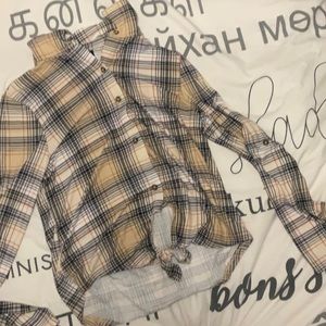Plaid long sleeve shirt with buttons and tied string at the front.